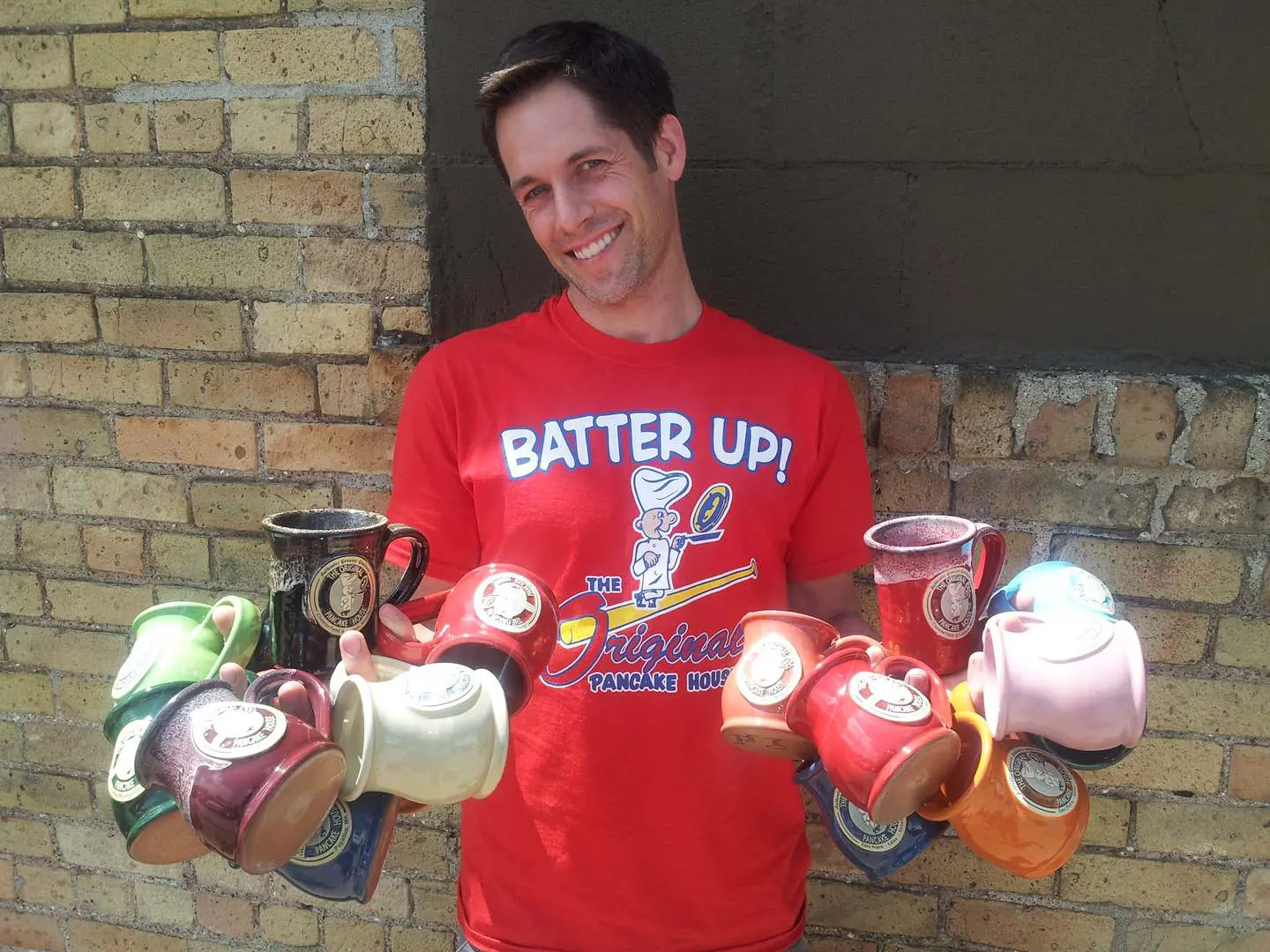 A man holding cans of batter up